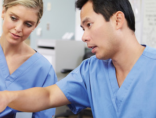 Two clinicians at a workstation 