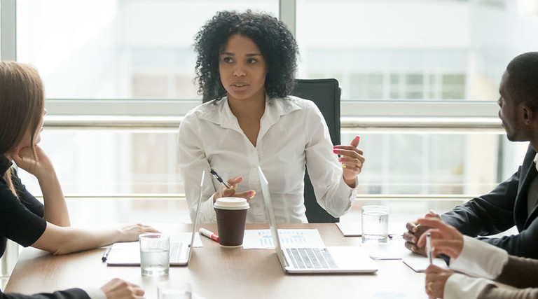 Healthcare CIO speaking with executives at a table