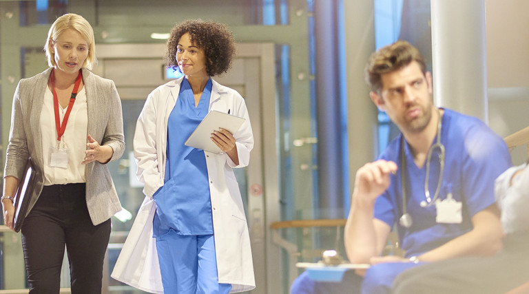 Doctor Speaks with PR Team in Hospital
