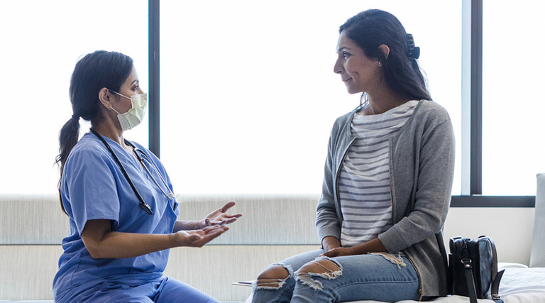 Doctor talking to patient in ER