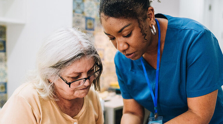 Nurse assisting senior patient