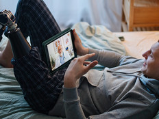 Man with prosthetic leg attends telehealth appointment at home